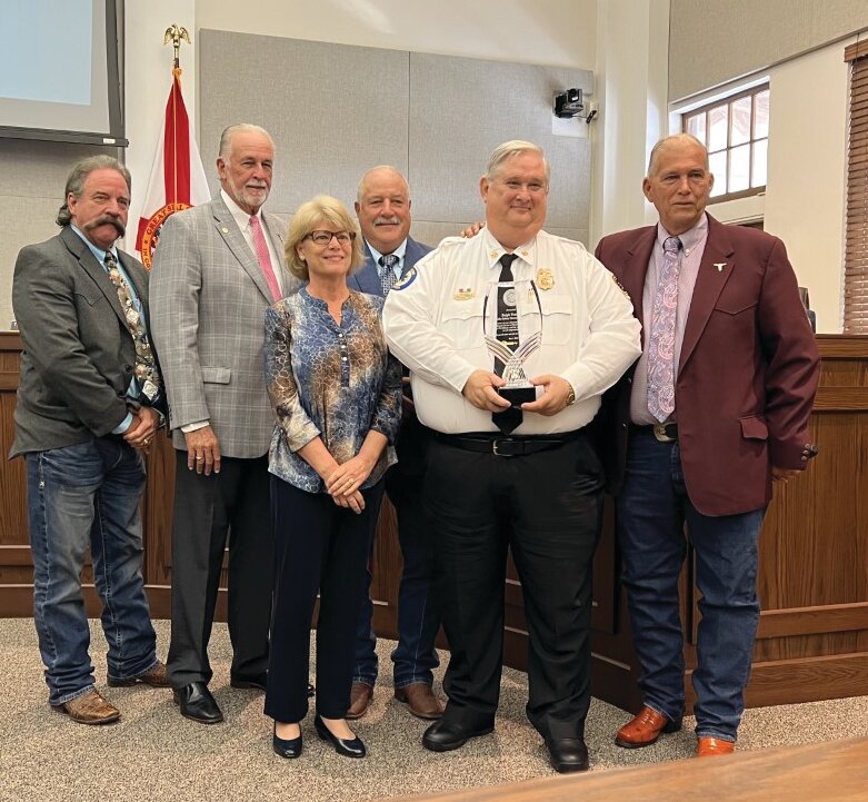 OKEECHOBEE -- At their April 27 meeting, Okeechobee County Commissioners honored Fire Chief Ralph Franklin. Left to right are Commissioner Brad Goodbread, Commissioner Terry Burroughs, Commissioner Kelly Owens, Commissioner Frank DeCarlo, Chief Franklin and Commission Chair David Hazellief.